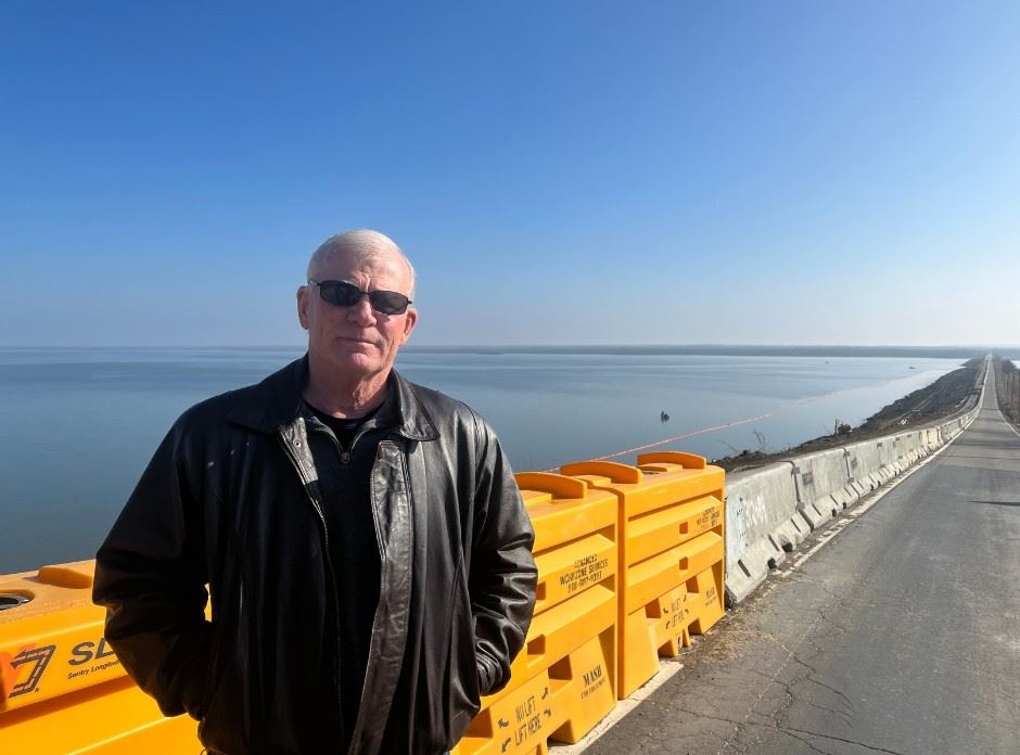 Photo with blue and yellow colors of District 2 Commissioner Steve Hendrix at Winganon Causeway